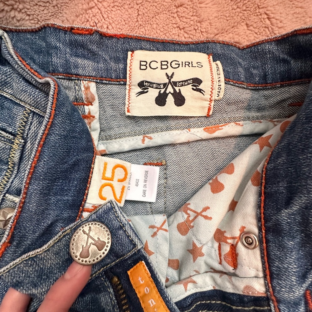 BCBGirls Blue Jeans with Distressed Detailing and Cream Leather Patch